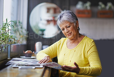 Buy stock photo Cafe, newspaper and senior woman reading daily news, article story or morning paper in store. Coffee shop customer, headline information and relax elderly person, female client or lady in restaurant