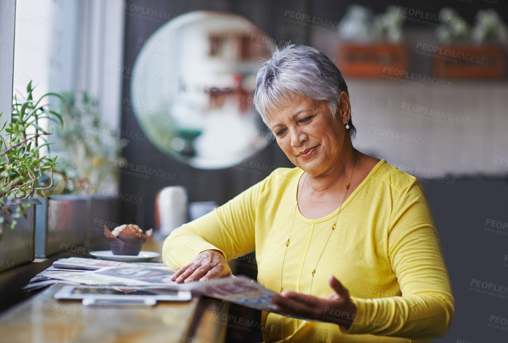 Buy stock photo Cafe, newspaper and senior woman reading daily news, article story or morning paper in store. Coffee shop customer, headline information and relax elderly person, female client or lady in restaurant