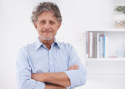 Buy stock photo A portrait of an optimistic businessman standing in his office