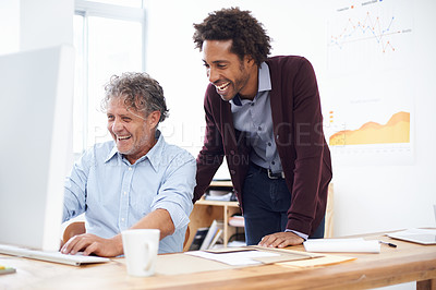 Buy stock photo Two coworkers in an office sharing a laugh about something they found on the internet