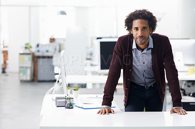Buy stock photo Portrait of a businessman leaning on a desk