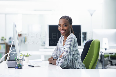 Buy stock photo Shot of a young businesswoman sitting at a desk