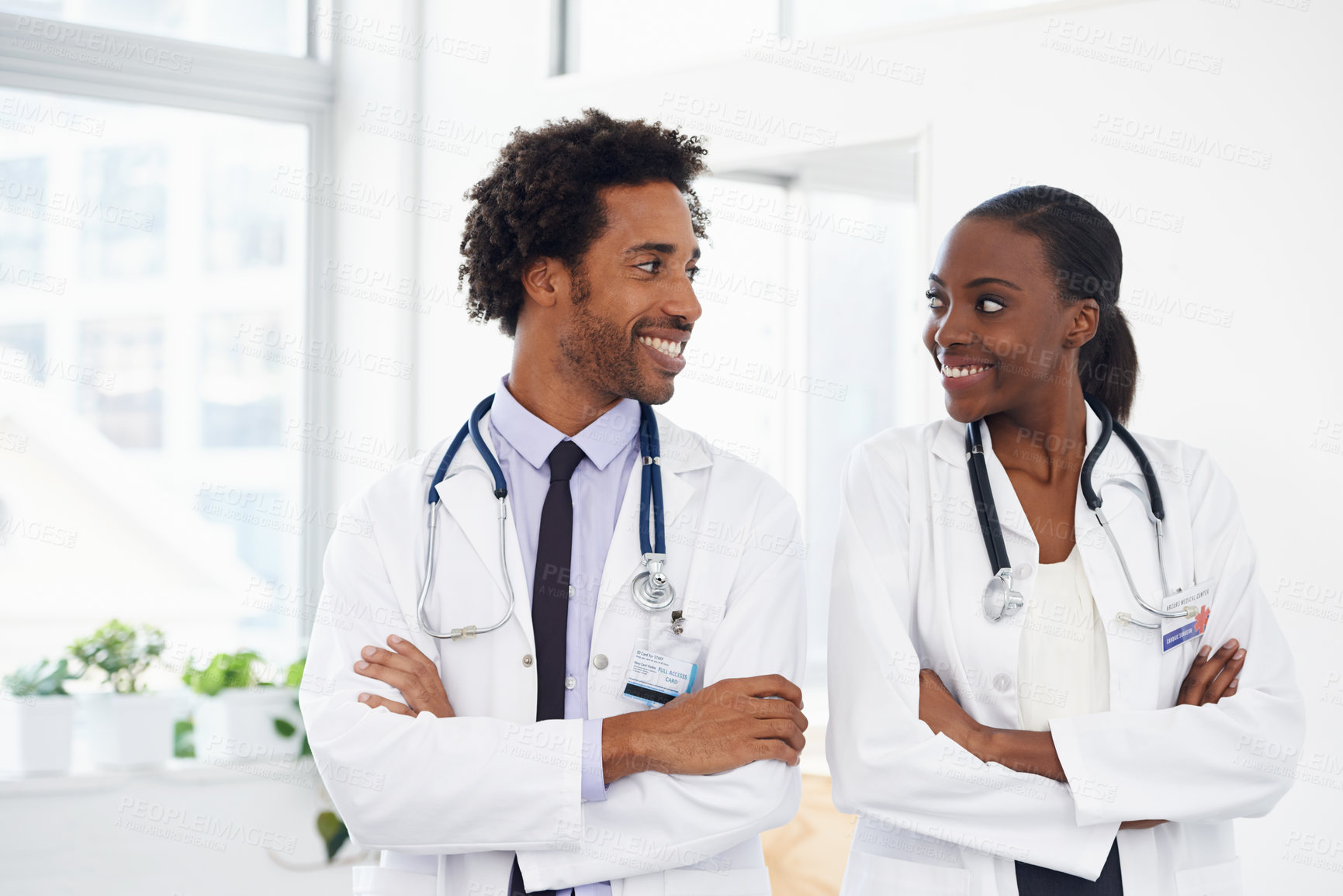 Buy stock photo Black people, smile and doctors with arms crossed for healthcare, confidence in medicine and team at hospital. Cardiovascular surgeon, health and medical professional collaboration with pride