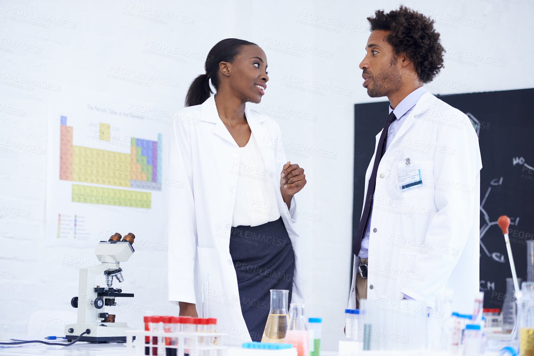 Buy stock photo Scientist, man and woman with discussion in laboratory for chemical research, medical review and study feedback. Science, african expert and collaboration with communication and chemistry planning