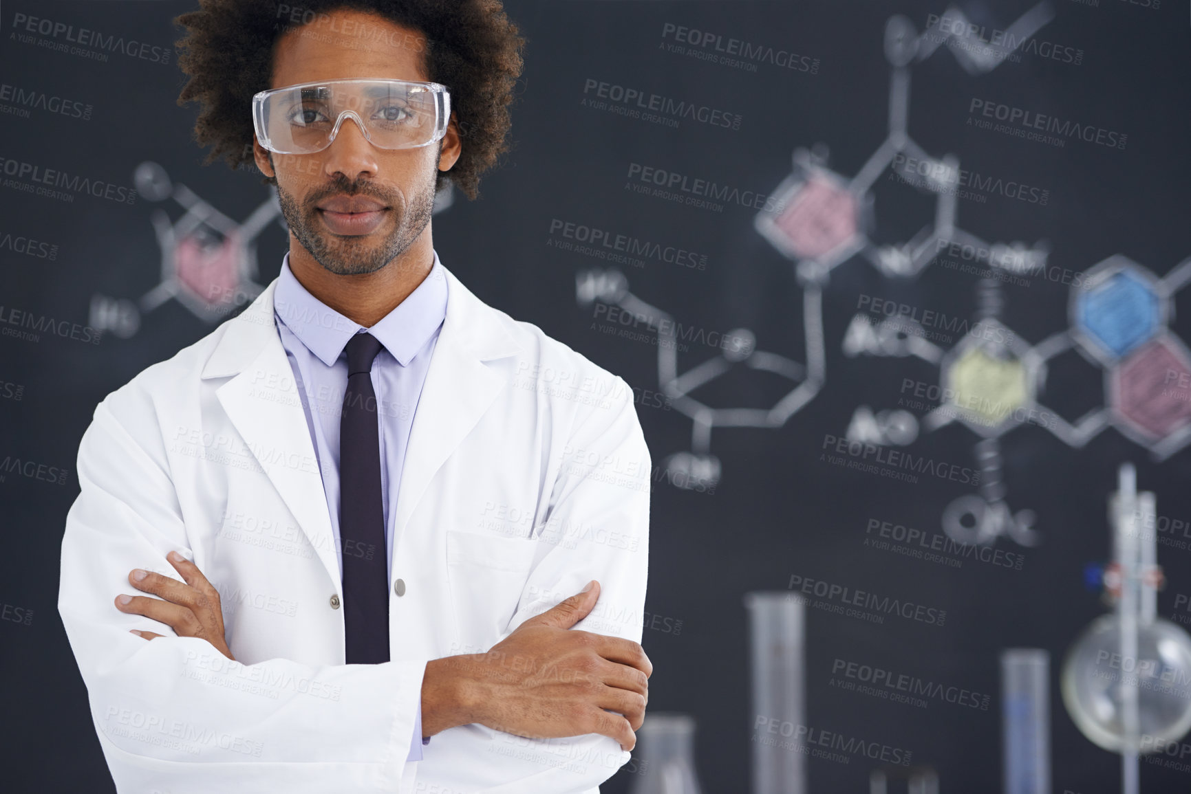 Buy stock photo A male scientist standing in front of a blackboard filled with drawings of chemical bonds