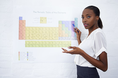 Buy stock photo Chemistry, education and element table for teacher in classroom for learn, teach or explain lesson. African educator and point with board for presentation, show and example for subject and understand