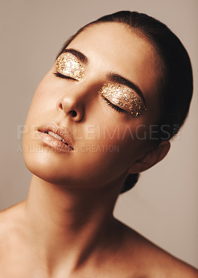 Buy stock photo Woman, face and gold glitter eyeshadow for beauty, cosmetology and glamour with cosmetics on beige background. Makeup, elegance and fashion model in studio, art or creativity with shimmer and glow