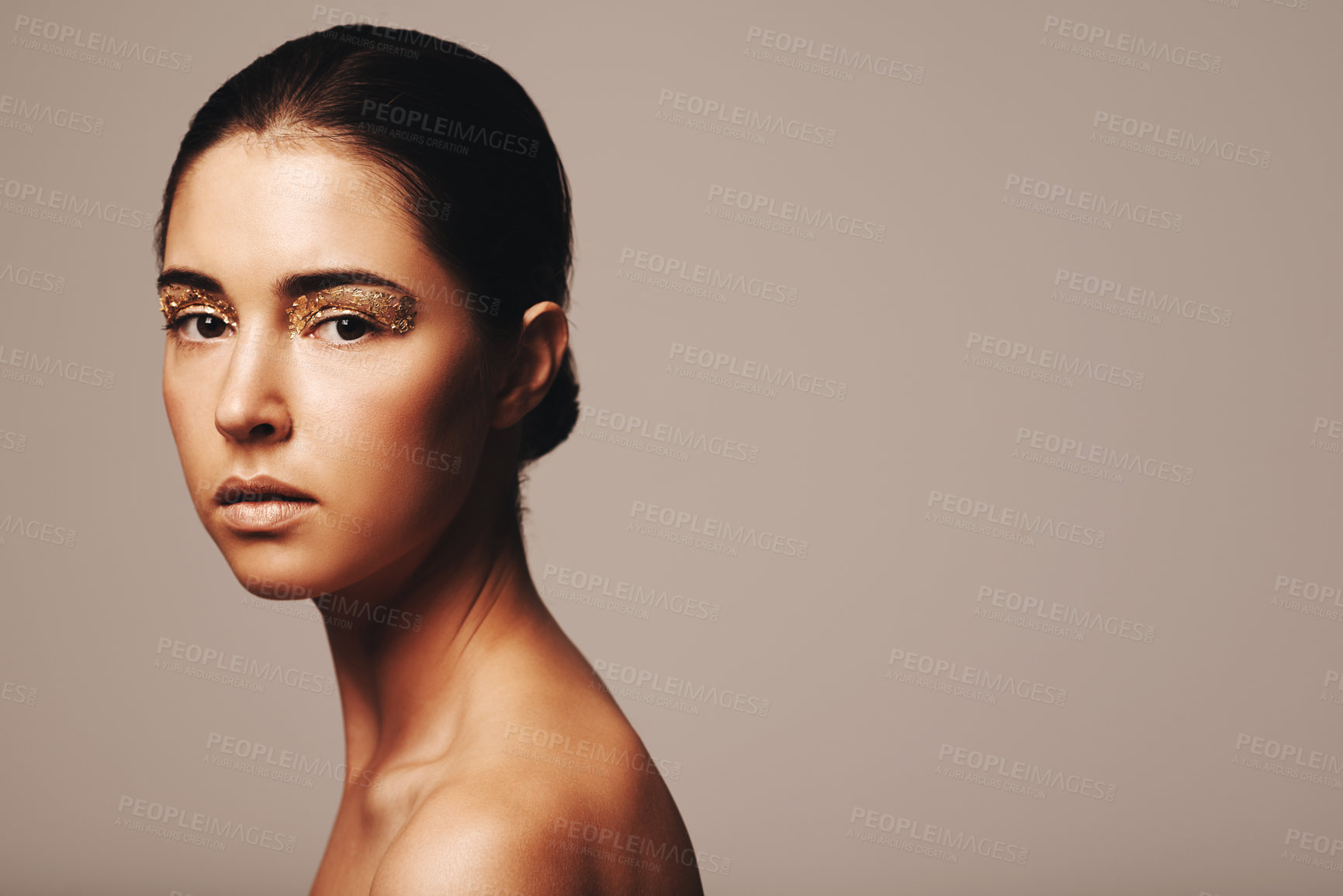 Buy stock photo Portrait of a beautiful and confident brunette wearing gold make up