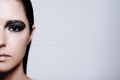 Buy stock photo Cropped portrait of a beautiful young woman wearing metallic-colored makeup