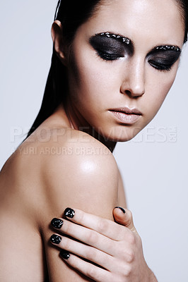 Buy stock photo Shot of a beautiful young woman wearing metallic-colored makeup and nail polish