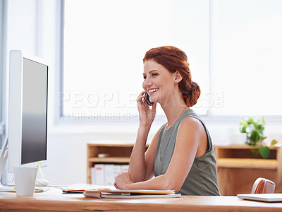Buy stock photo Shot of an attractive young businesswoman talking on the phone while sitting at her desk