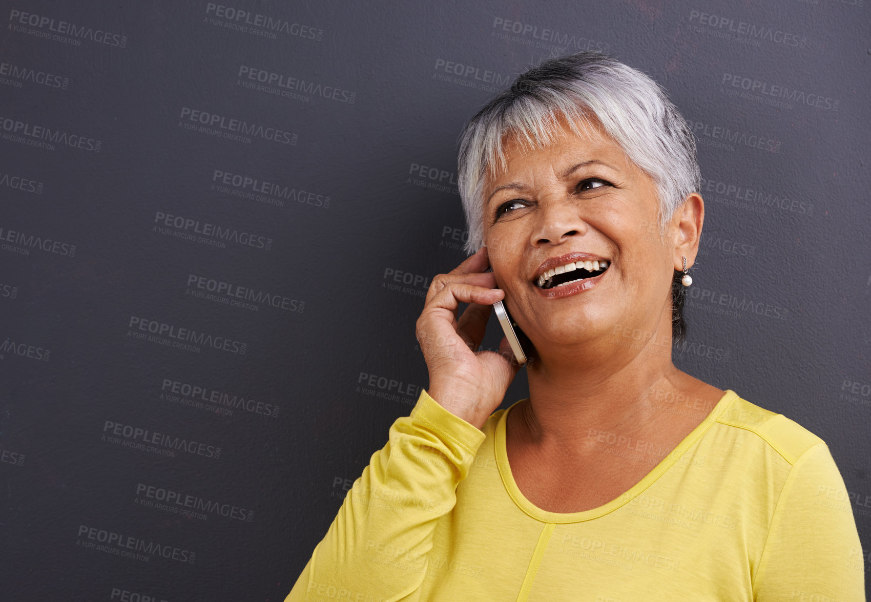 Buy stock photo Happy, phone call and senior woman in studio for communication, good news or gossip. Contact, mockup and elderly female person on mobile conversation with cellphone for talking by black background.