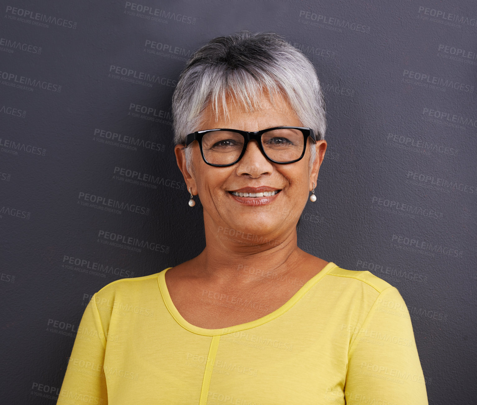 Buy stock photo Portrait of a mature woman standing in a studio