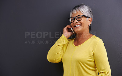 Buy stock photo Glasses, phone call and senior woman in studio for communication, good news or gossip. Contact, mockup and elderly female person on mobile conversation with cellphone for talking by black background.
