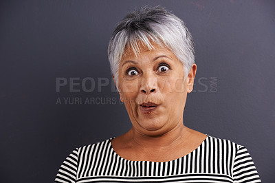 Buy stock photo Surprise, portrait and senior woman in studio with crazy, silly or crazy facial expression for comedy. Shock, comic and elderly female person with wow, omg or wtf face isolated by gray background.