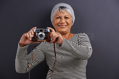 Buy stock photo Portrait, camera and photography with senior woman, creative and artistic on a dark studio background. Face, model and mature lady with photographer and hipster style with confidence and freelancer