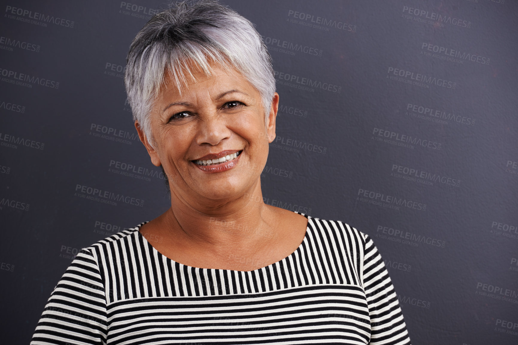 Buy stock photo Portrait of a mature woman standing in a studio