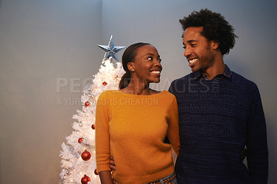 Buy stock photo Christmas, tree and black couple with love in home on holiday or hug on vacation with happiness. Festive, house and people embrace with care and support or excited to celebrate at event together