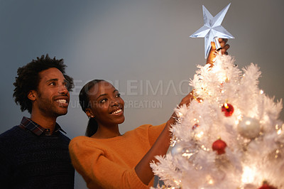 Buy stock photo Couple, Christmas and tree with star decoration for holiday celebration in winter season for festive, giving or presents. Man, woman and lights in living room for bonding vacation, event or tinsel
