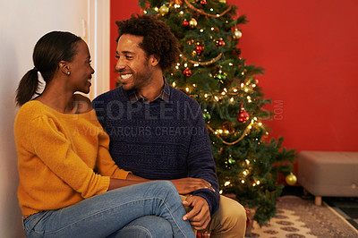 Buy stock photo Christmas, love and black couple in home on holiday or holding hands on vacation with happiness. Festive, tree and people embrace with care and support in house or excited to celebrate together