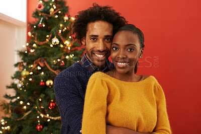 Buy stock photo Couple, portrait and Christmas celebration in home at tree for vacation bonding with embrace, festive or season. Man, woman and hug in living room for present giving with smile, holiday or relaxing