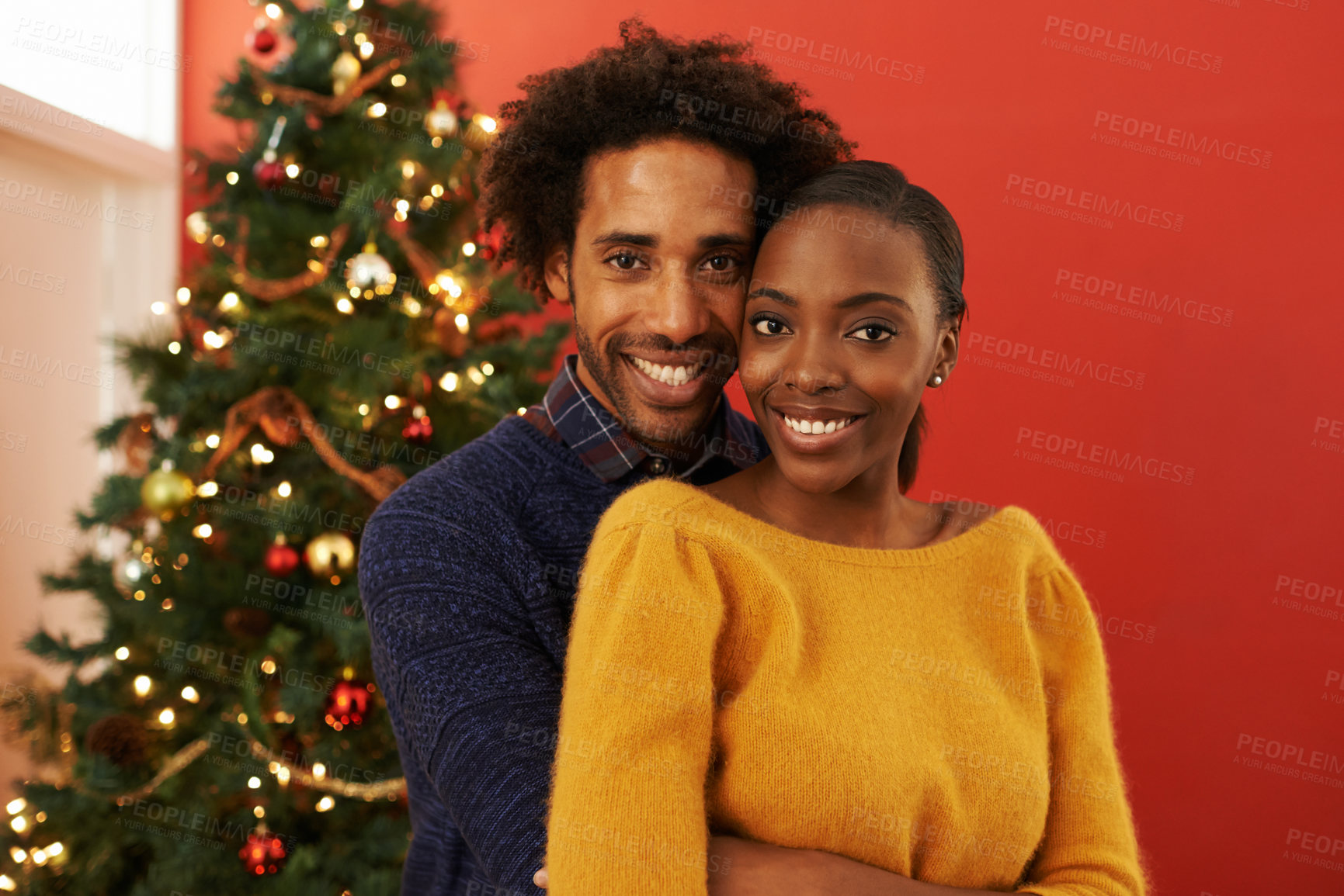Buy stock photo Couple, portrait and Christmas celebration in home at tree for vacation bonding with embrace, festive or season. Man, woman and hug in living room for present giving with smile, holiday or relaxing