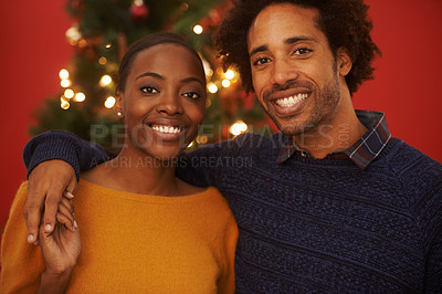 Buy stock photo Christmas, tree and portrait of black couple with love in home on holiday or hug on vacation with happiness. Festive, event and people embrace with care and support or excited to celebrate together