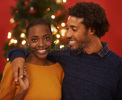 Buy stock photo Christmas, tree and portrait of black couple with love in home on holiday or hug on vacation with happiness. Festive, event and people embrace with care and support or excited to celebrate together