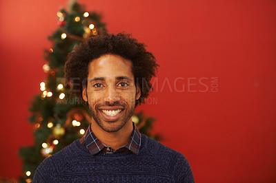Buy stock photo Man, portrait and smile or Christmas celebration at tree with red background for mockup space, holiday or vacation. Male person, face and festive season with light decoration or present, joy or break