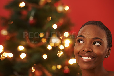 Buy stock photo Christmas, thinking and black woman in home with tree for festive holiday and planning vacation. Happy, girl or excited for xmas in winter and ideas for house on red background in mockup space
