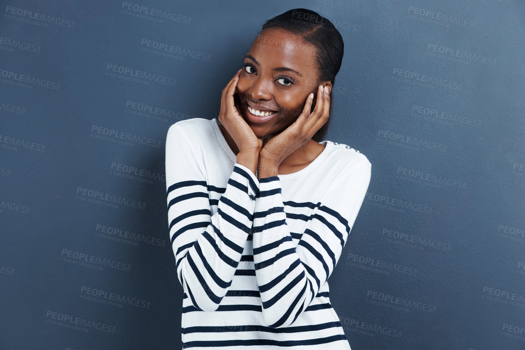 Buy stock photo Shy, black woman and hands on face peeping in studio isolated on grey background. Portrait, fingers and African female person embarrassed, emotions and reaction with social anxiety and expression