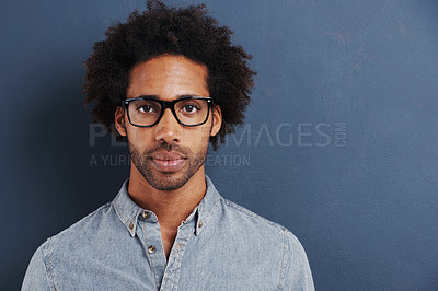 Buy stock photo Portrait of a handsome young man wearing glasses on a gray background