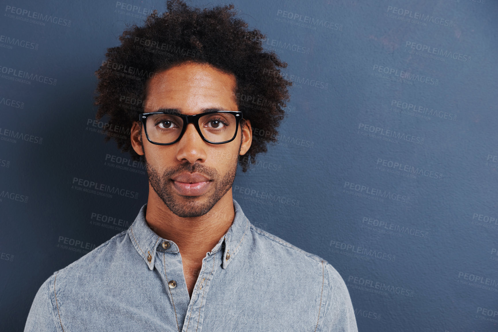 Buy stock photo Portrait of a handsome young man wearing glasses on a gray background