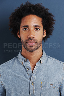 Buy stock photo Young man, portrait or confident in studio as creative professional or casual fashion by blue background. Brazil person, face and afro for ambition as designer and trendy clothes or relax in closeup