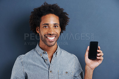 Buy stock photo Man, portrait and cellphone for texting in studio or online connection on blue background, mockup or typing. Male person, smile and internet or reading email or communication, message or social media