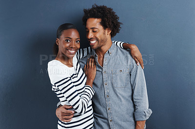 Buy stock photo Happy, portrait and black couple hug with love on studio background and happiness in marriage. Embrace, together and people smile with care and support in partnership or casual fashion or style