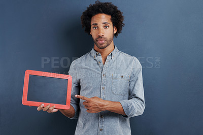 Buy stock photo Blackboard, portrait and man with hand pointing to mockup in studio for news announcement on grey background. Frame, presentation or face of male model show space for promotion, info or sign up guide