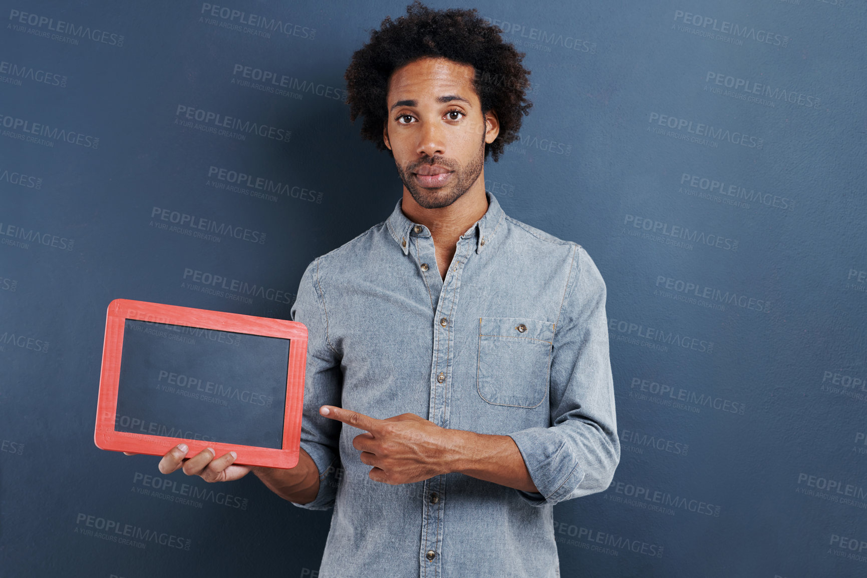 Buy stock photo Blackboard, portrait and man with hand pointing to mockup in studio for news announcement on grey background. Frame, presentation or face of male model show space for promotion, info or sign up guide
