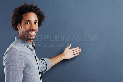 Buy stock photo Portrait, smile or man with hand pointing to mockup in studio for news, offer or giveaway info on grey background. Happy, face or male model show space for deal presentation, opinion or sign up promo