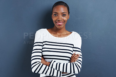 Buy stock photo Portrait, happy and black woman with arms crossed, fashion and model on a blue studio background. Face, African person and girl with casual outfit and stylish clothes with smile and mockup space