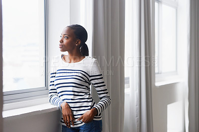 Buy stock photo Woman, serious and thinking by window in new home with confidence for real estate investment and mortgage. African homeowner, thoughtful and relax with future house ideas or relocation in living room