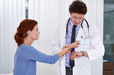 Buy stock photo Doctor, patient and wrist pulse for heart rate consultation in hospital for blood pressure examination, diagnosis or test. Male person, woman and professional for illness symptoms, advice or clinic