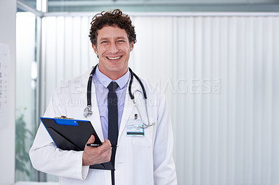 Buy stock photo Cropped shot of a handsome doctor smiling happily at the camera