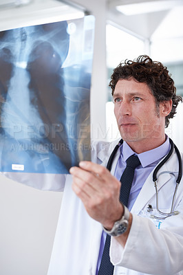Buy stock photo Doctor, man and xray in hospital to check results with thinking for lungs, decision and healthcare. Professional medic, reading and film paper with respiratory system exam for asma at wellness clinic