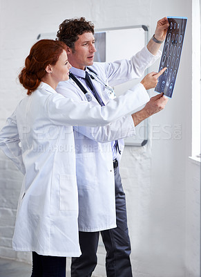 Buy stock photo Doctors, brain scan and check results at clinic with teamwork, review and healthcare by window. Neurology, man and woman with xray reading for wellness, ideas and decision with document at hospital