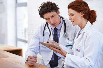 Buy stock photo Doctors, man and woman on tablet in hospital for team, planning and review for medical results. Medic employees, people and digital touchscreen in clinic for collaboration with telehealth services