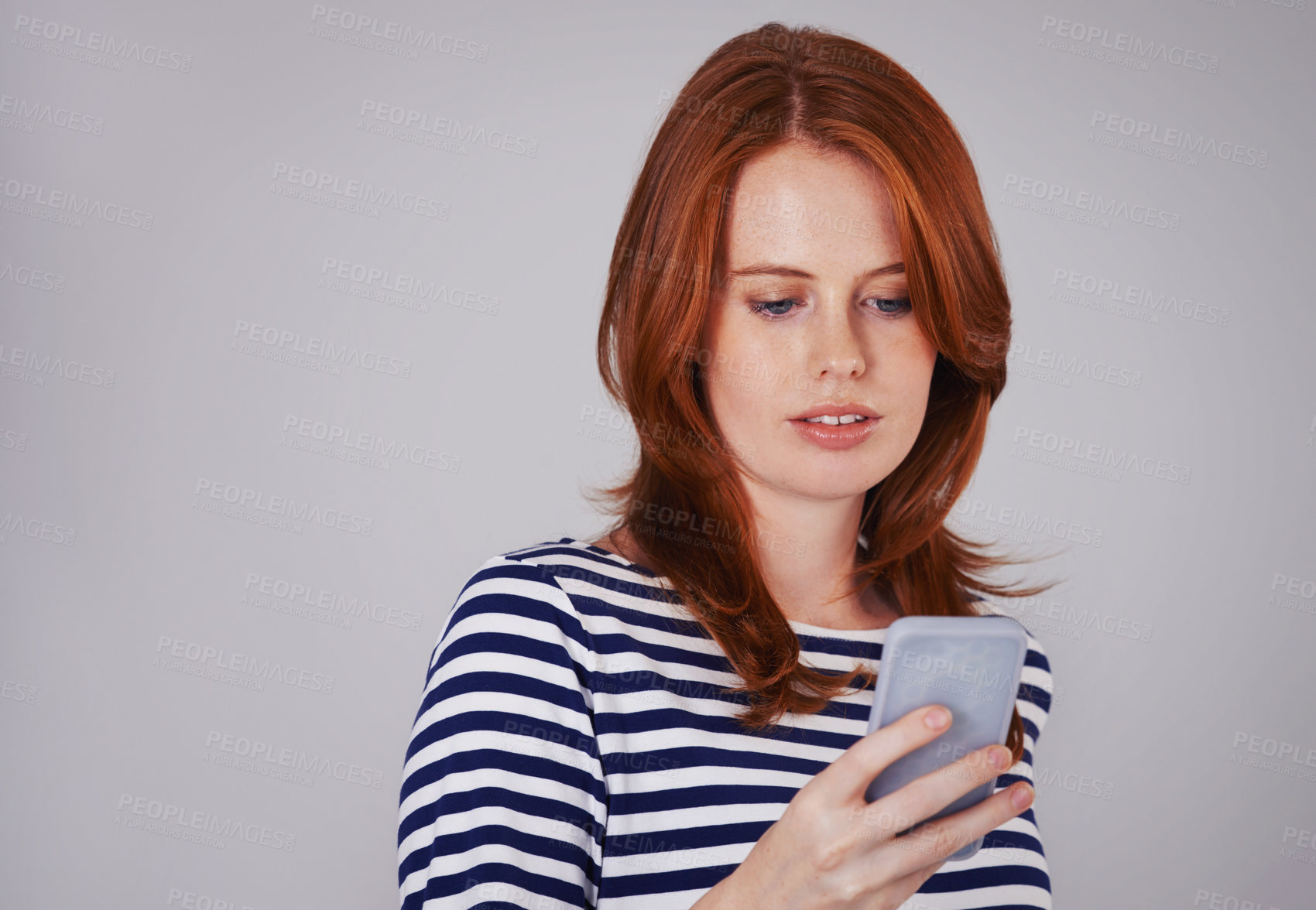 Buy stock photo Woman, phone and typing for communication in studio, internet and app for conversation or chat. Female person, mockup space and scroll on social media on gray background, blog and online information