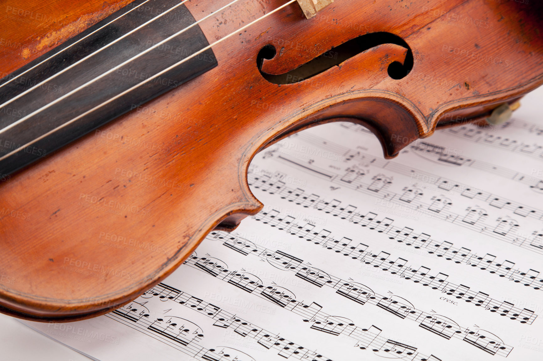 Buy stock photo Cropped shot of a violin lying atop sheet music