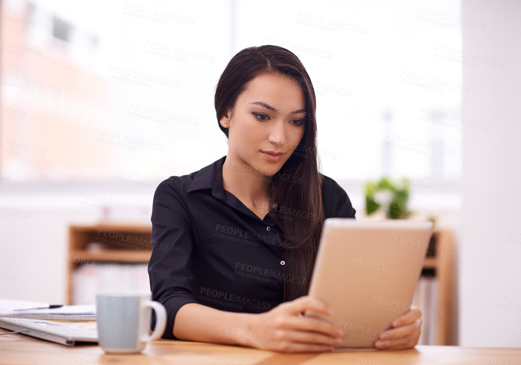 Buy stock photo Shot of a young businesswoman in her office