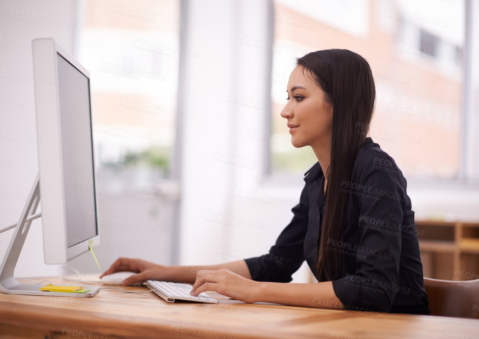 Buy stock photo Shot of a young businesswoman in her office